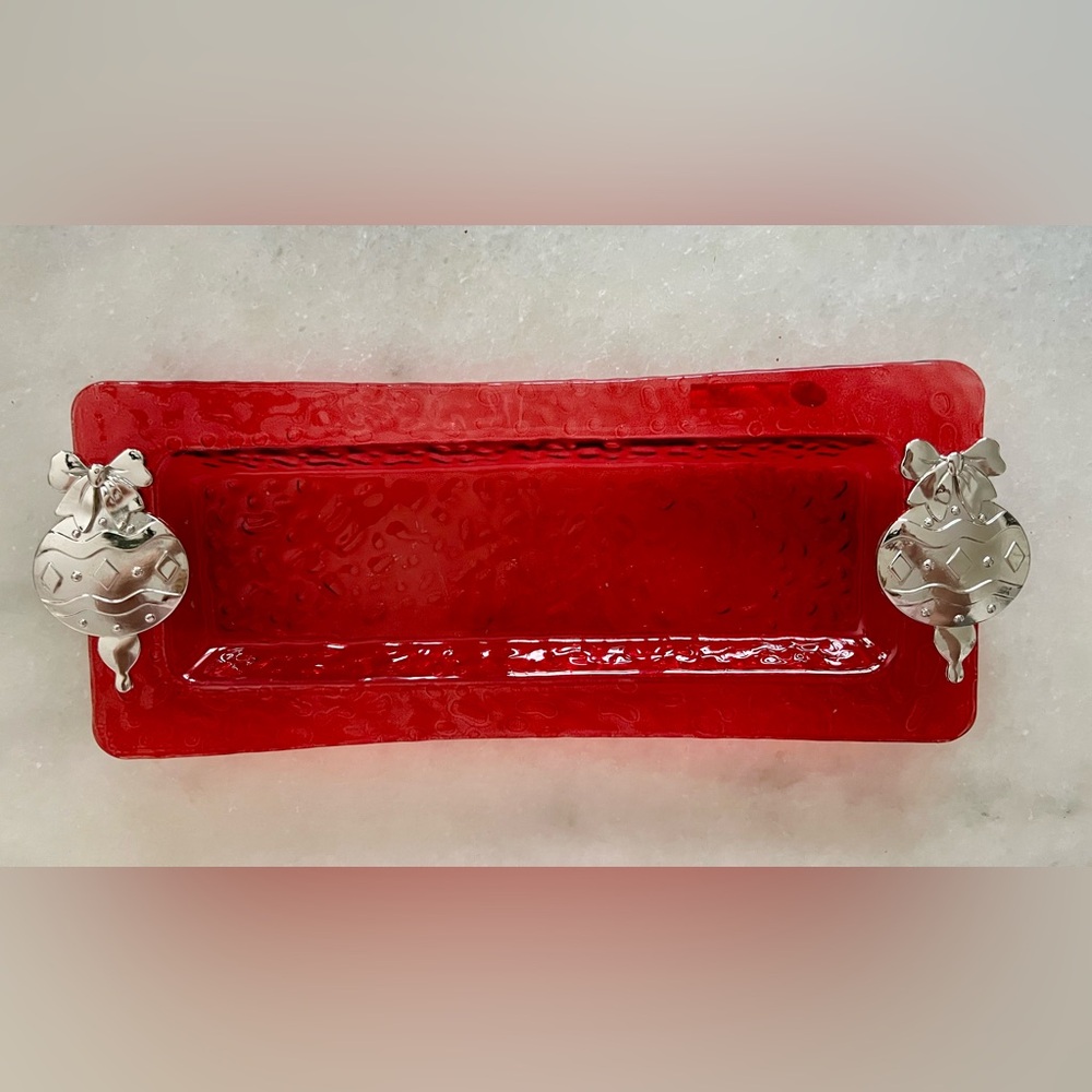 Holiday red glass serving tray with silver ornaments. 
14.5” x 6.5”.